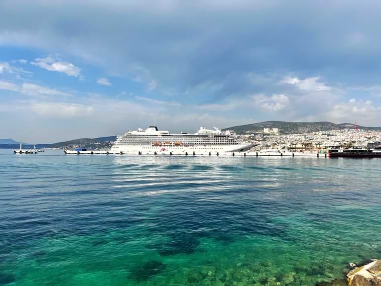 shining turquoise water of the Aegean Sea and Cruise Ship in Kusadası Port which is set in a heavenly bay