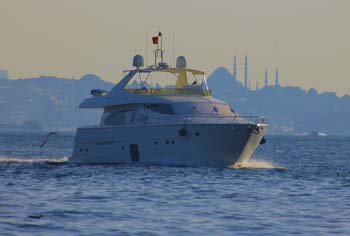 Private yacht boat on the Bosphorus and Istanbul's historical mosques in the background